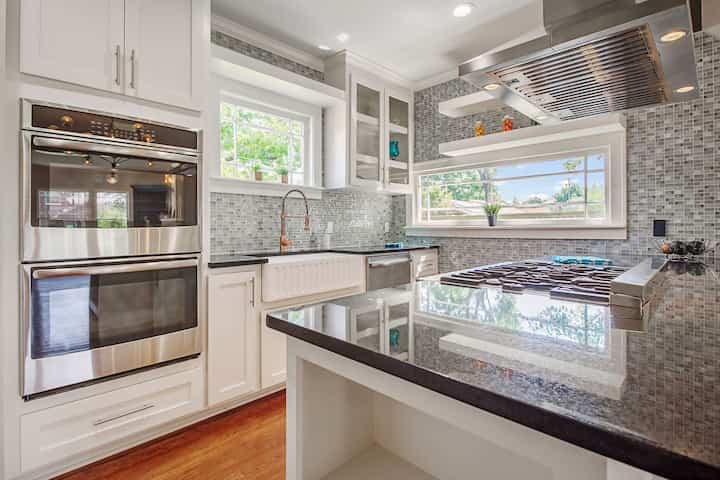An image of a modern kitchen with sleek appliances, featuring a gas stove, refrigerator, and built-in microwave in Princeton